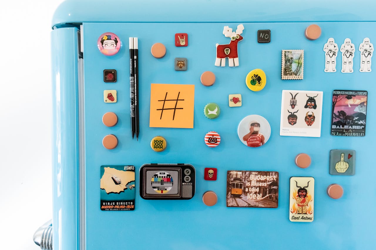 A vibrant collection of fridge magnets and notes on a blue refrigerator with ample copy space.
